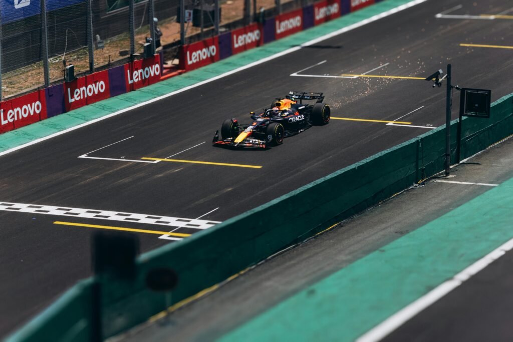 A Formula 1 car speeds down the track during a race, showcasing high performance.